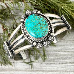 Sterling Cuff with Kingman Spiderweb Turquoise    Handmade by Navajo artist, Michael Calladitto    Signed and marked sterling    Weighs about 65 grams    Nice and sturdy bracelet with lots of detail    Inside of bracelet measures about 5 5/8" plus a 1 3/8" gap = total wrist size 7"   Bracelet Sizing  The wrist size is the measured by taking a cloth tape measure around the portion of your wrist where you want to wear the bracelet.  The bracelet size measurement is the TOTAL inner circumference of Handmade Western Turquoise Bracelets, Handmade Western Turquoise Bracelet, Handmade Western Style Turquoise Bracelet, Southwestern Stamped Cuff Bracelet For Gift, Southwestern Concho Cuff Bracelet Gift, Southwestern Stamped Cuff Bracelet As Gift, Artisan Cuff Bracelet With Concho As Gift, Artisan Concho Cuff Bracelet As Gift, Collectible Bohemian Turquoise Bracelets