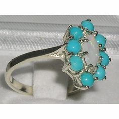 *This floral design ring is made from14K White Gold and handset with Natural Opal & Turquoise. The centre opal is Marquise cut and measures 8x4mm (0.32"x0.16" inches) Opal and is surrounded by eight 3mm (0.12" inches) Turquoise gemstonesHandcrafted from 14K White Gold and hallmarked by the London Assay Office which confirms the rings authenticity. The Hallmark includes the 585 purity mark for 14K gold  All the Gemstones are Genuine Natural & Ethically SourcedPLEASE INCLUDE YOUR TELEPHONE Turquoise Engagement Ring, Turquoise Ring Engagement, Turquoise Design, Toddler Hair Accessories, Turquoise Gold Ring, Glitter Hair Bows, Flower Accessories, Ring Engagement, Marquise Cut