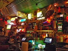 a room filled with lots of neon signs and lights