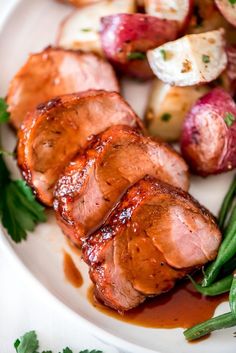 some meat and vegetables on a white plate