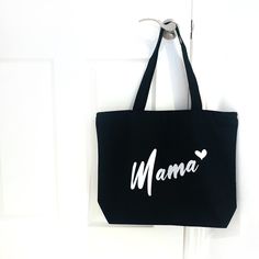 "Our MAMA SHOPPER BAGS' make the perfect Bag for on the GO! They fold up small - but hold a lot!  Choose from our different Colours. They make a perfect Gift for any MAMA!  This Listing is for a Black Mama Shopper Bag.  MATERIAL:  The Bags are made of 100% Canvas, full Zippered Closure on the Top and a small inside zippered Pocket.  SIZE: 50cm x 38cm x 12cm  =  20'' x 15'' x 5\"  BAG COLOUR OPTIONS: - Black - Natural (other Listing)  - Navi Blue (other Listing)  FONT COLOUR OPTIONS: - Black - White  - Gold - Hot Pink - Lime Green - Red CARE:  - Machine washable in Warm Water.  - Hang or Lay Flat to Dry.  - Do NOT Iron directly on Heat Transfer Name Designs - Iron only with Heat resistant Layer in-between - like a cotton sheet for example.  All our Items are made in a Smoke Free environment Black Bags For Daily Use And Mother's Day, Black Bags For Daily Use On Mother's Day, Black Bags For Mother's Day Shopping, Black Everyday Shoulder Bag For Mother's Day, Black Rectangular Shoulder Bag For Mother's Day, Black Shoulder Bag For Everyday, Black Canvas Shopping Gift Bag, Black Large Capacity Bag For Mother's Day, Black Gift Bag For Mother's Day