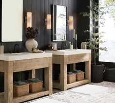 a bathroom with two sinks, mirrors and plants in vases on the counter top