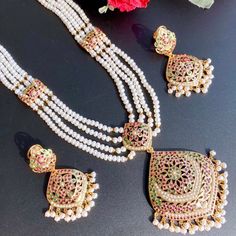 Featuring a traditional jadau haar in gold plated silver embellished with freshwater pearls and synthetic rubies and emeralds. Festive Pearl Jewelry With Meenakari, White Meenakari Pearl Necklace In Temple Jewelry Style, White Pearl Necklace With Meenakari For Temple, White Meenakari Pearl Necklace For Temple Jewelry, Festive Meenakari Pearl Jewelry, White Kundan Temple Necklace With Intricate Design, Traditional Pearl Necklace With Meenakari For Celebration, Traditional Bridal Necklace With Meenakari And Pearls, Traditional Pearl Bridal Necklace With Meenakari