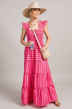 The “Lynlee Stripe Maxi” boasts alternating pink and red stripes for a bold summer look. The stretchy smocked bodice is met with a ruffle tiered skirt, and smocked flutter sleeves complete the look.  offered in 3 colors    Pull-on fit  Smocked straps  Stretchy smocked bodice  Fabric content: Self- 100% polyester  Fabric has no stretch (aside from smocking)   Fit is true to size. Model (5'3") is wearing size small. Pink Tiered Smocked Dress With Smocked Back, Pink Smocked Dress With Ruffle Hem And Straps, Pink Tiered Smocked Dress, Casual Striped Smocked Dress, Chic Pink Tiered Smocked Dress, Pink Ruffled Smocked Dress For Day Out, Casual Striped Smocked Dress For Spring, Casual Striped Smocked Dress With Smocked Bodice, Pink Tiered Smocked Dress With Ruffle Hem