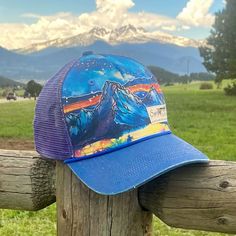 *Please note some of the images show the hat with the larger woven logo. The logo on this hat is the small Sipsey Wilder rubber logo. This hat is a collaboration with Chilean water colorist Vicki Speck. Her gorgeous water color paintings of mountains and nature will be seen on more products to come! Check her out on instagram @vickispeckart Made from 100% recycled cotton and purple polyester mesh, this completely rad trucker is printed with an original water color painting by Vicki Speck. Royal Paintings Of Mountains, Dinosaur Mask, Color Painting, Mountain Paintings, Cat Nap, Live In The Now, Meet The Artist, Recycled Cotton, Beautiful World