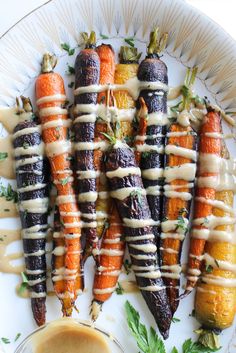 an assortment of carrots on a plate with dressing