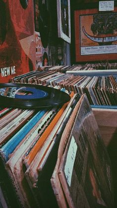 an old record player sitting on top of a pile of records