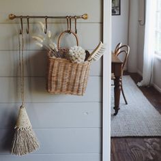 a wicker basket hanging on the wall next to a door