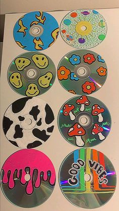 six cd's with different designs on them