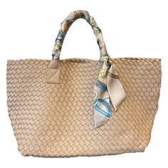 Woven Vegan Leather Tote! This luxurious woven Khaki tote is made from a premium performing alternative to leather, each bag is hand-woven by artisans. The tote includes double reinforced top handles and tie straps inside to adjust bag size, as well as a detachable zipper pouch. Perfect for use as a on-the-go tote or a shoulder bag for everyday wear. Water resistant material, bag is not water proof due to open weave of the material. Silk scarf included with the tote. Dimensions: 16" wide x 11" h Eco-friendly Woven Shoulder Bag With Double Handles, Eco-friendly Handwoven Straw Bag With Double Handle, Eco-friendly Rectangular Handwoven Straw Bag, Eco-friendly Beach Bag With Woven Leather And Natural Fiber, Eco-friendly Handwoven Rattan Bag, Photography Lenses, Vegan Leather Tote, Woven Tote Bag, Open Weave