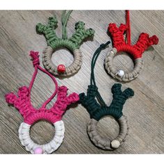 three crocheted ornaments are sitting on the floor