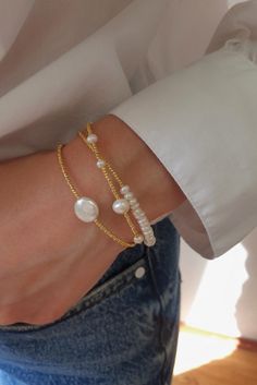 Adorn your wrist with the exquisite charm of our Dainty Pearl Triple Bracelet. This triple bracelet, delicately crafted on three chains, combines the timeless allure of pearls with the sophistication of gold-plated elegance. Elevate your style with the understated beauty of this triple-strand bracelet—a symbol of triple elegance. 🌼💫 #PearlTripleBracelet #GoldPlatedElegance #DaintyBrassBracelet #TimelessCharm Elegant Handmade Gold Plated Pearl Bracelet, Elegant Handmade Gold-plated Pearl Bracelet, Handmade Elegant Gold-plated Pearl Bracelet, Elegant Adjustable Pearl Charm Chain Bracelet, Elegant Adjustable Chain Bracelet With Pearl Charm, Handmade Adjustable Gold-plated Pearl Bracelet, Elegant Bangle Bracelets For Layering, Elegant Handmade Gold-plated Beaded Bracelets, Elegant Handmade Gold-plated Beaded Bracelet