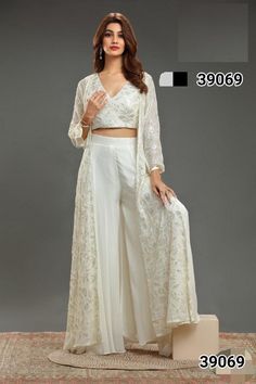 Bathed in a soft, ethereal glow, the pearl white sharara and jacket set exudes timeless elegance. The delicate embroidery glistens like frost on a winter morning, weaving intricate patterns across the pristine fabric. The sharara flows gracefully, while the jacket adds a touch of regal refinement. Draped in this ensemble, she becomes a vision of serene sophistication, embodying a perfect blend of classic beauty and modern grace. Size M-38  Chest/Bust Size:38" Waist Size:36" Kurti Length:37" Size White Sharara, Punjabi Dress, Simple Blouse Designs, Winter Morning, Delicate Embroidery, Simple Blouse, Indian Suits, Sharara Set, Pakistani Suits