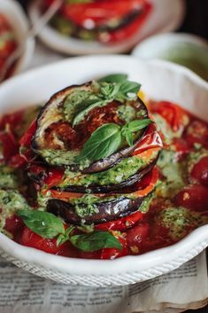 a white bowl filled with food on top of a table