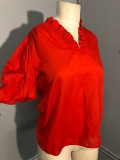 Super fun red blouse, zip up back. Modern size M. Mannequin measurements:  Bust: 36 inches  Waist: 27 Hips: 37 Red Short Sleeve Cotton Blouse, Red Ruffled Stretch Tops, Red Stretch Ruffle Tops, Red Stretch Shirt For Summer, Red V-neck Shirt For Spring, Red Stretch Blouse For Fall, Red Stretch Cotton Blouse, Red Retro Summer Blouse, Vintage Red Cotton Blouse