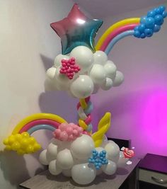 balloons and streamers are arranged in the shape of stars, clouds, and rainbows