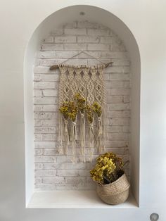 a potted plant sitting on top of a shelf next to a white brick wall