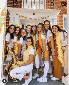 a group of women posing for a photo in front of a building