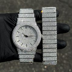 Step into elegance with this fully iced-out diamond watch and bracelet set that mirrors genuine luxury watches. We utilize premium simulated diamonds crafted from high-refractive crystals, ensuring a sparkle that rivals authentic diamonds under the light! INCLUDES AN EASY-TO-USE SIZE ADJUSTMENT TOOL Specifications: - Gender: Men's - Case Size: 46mm - Sizing: 8.5-inch band - Bracelet Length: 9-inches (Non-adjustable) - Movement: Quartz Movement - Battery: Included - Adjustable: Watch Links are re Iced Out Jewelry Men, White Gold Diamond Watch With Rhinestones, Iced Out Diamond Jewelry And Watches For Gifts, Silver Watch With Rhinestones And Cubic Zirconia, Silver Cubic Zirconia Watch With Rhinestones, Luxury Stainless Steel Jewelry With Rhinestones, Luxury Rhinestone Stainless Steel Jewelry, Silver Diamond Watch With Cubic Zirconia Bling, Cubic Zirconia Diamond Watch With Bling