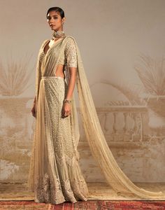 Step into sophistication with this silver green persian embroidered sari set – a perfect harmony of tradition and contemporary flair. This stunning ensemble features a pre-draped sari and drape blouse, intricately embroidered in silver green motifs. The striking color and persian-inspired design add a regal touch, making it an ideal choice for special occasions. Traditional Embellished Pre-draped Saree In Raw Silk, Elegant Pre-draped Pista Green Saree With Sheer Dupatta, Embellished Anarkali Pre-draped Saree In Art Silk, Pista Green Pre-draped Saree For Diwali, Fitted Pista Green Pre-draped Saree For Eid, Transitional Season Reception Pre-draped Saree With Dupatta, Embellished Raw Silk Saree With Traditional Drape, Embellished Anarkali Tissue Silk Pre-draped Saree, Anarkali Style Embellished Tissue Silk Pre-draped Saree