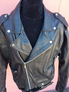 "Vintage secondhand unisex \"PLG\" (World Wide Putnam Leather Gold) black genuine leather double-breasted Brando biker-style heavy, well made motorcycle jacket with zippers, lots of pockets & belt. Nice black quilted lining. Inner pocket. Tag size 46 Underarm to underarm is 22\"ish Top back collar to bottom is 29\" Shoulder seam to end of sleeve is 26\" In very good overall used lightly shape. Missing in 1 zipper. Some minor scuffs & such." Black Moto Leather Jacket With Belt Loops, Biker Jacket With Belt Loops, Biker Jacket With Belt Loops For Biker Events, Punk Biker Jacket With Zip Fly For Biker Events, Vintage Black Leather Jacket With Front Zip, Classic Black Biker Jacket With Belt Loops, Pueblo Native Americans, Motorcycle Black, Santa Fe Nm