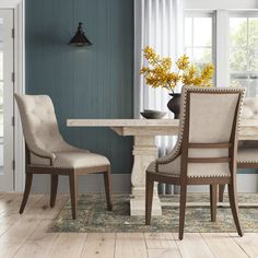 a dining room with blue walls and wooden floors