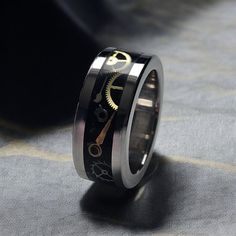 This exquisite handmade ring features a durable 6mm stainless steel core, ensuring longevity and strength. The unique design incorporates a 4mm authentic Swiss watch movement parts inlay, elegantly encased in high-quality resin, creating a striking visual effect. Each piece is meticulously crafted, making it a perfect accessory for those who appreciate fine craftsmanship and distinctive style. Ideal for both casual and formal occasions, this ring is a statement of sophistication and individualit Steampunk Casual, Cnc Lathe, Inner Core, Watch Parts, Watches Unique, Ring Unique, Vintage Watches, Rings Statement, Unique Rings