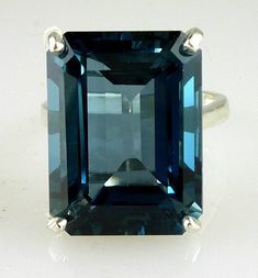 ALL OUR JEWELRY IS HANDCRAFTED IN THE U.S.A. Lovely as the clear, radiant blue of island seas... This exquisitely emerald cut London Blue Topaz is of rare great size not seen in a London Blue Topaz a full 25.50 carats-- catching the light and dazzling your friends. This ring is sure to capture the attention of many admiring glances. And this great traditional design of the setting perfectly complements this great stone. Set in solid .925 sterling silver. You will love it... London Blue Topaz, (1 Blue Topaz Ring Sterling Silver, Sky Blue Topaz Ring, Gold Skies, Filigree Ring Gold, London Blue Topaz Ring, Circle Diamond, Sky Blue Topaz, Silver Chain Bracelet, Swiss Blue Topaz