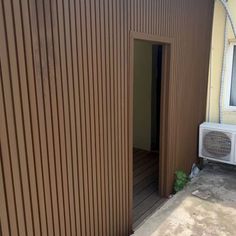 an outside view of a house with a small air conditioner on the side of it