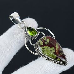 Dragon Blood Jasper, Peridot Gemstone Handmade 925 Sterling Silver Jewelry Pendant Premiun Quality Gemstone Pendant For Women Christmas Gift ❏ Product Information ●  Gemstone Type - Dragon Blood Jasper ●  Secondary Gemstone - Peridot  ●  Main Stone Creation - Natural ●  Pendant Size - 6.5 Cm. ●  Metal Type - 925 Sterling Silver With 925 Stamped ●  United States ( UPS, DHL Express ) ●  Other Countries ( India Post, Dhl ) ●  Free Shipping Worldwide ●  We Will Provide You Tracking number ●  Add Gif Green Gemstones With Accents For Gifts, Green Gemstones With Accents As Gifts, Green Gemstones With Stone Setting For Gifts, Green Multi-stone Gemstones For Gift, Green Natural Gemstones As Gift, Petrified Wood Jewelry, Dragon Blood, Pendant For Women, Peridot Gemstone