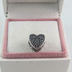 a heart shaped ring in a white box