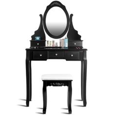 a black vanity with a mirror and stool