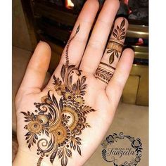 a person's hand with henna tattoos on it