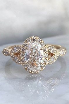 an oval shaped diamond ring with two rows of diamonds on the band