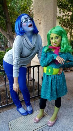 two women dressed in costumes standing next to each other