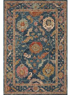 a blue rug with floral design on the bottom and border in red, orange, yellow and green colors