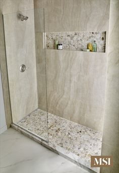 a walk in shower sitting inside of a bathroom