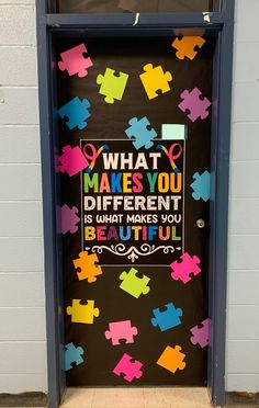 a door decorated with puzzle pieces and the words what makes you different is what makes you beautiful