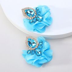 These exquisitely crafted Floral Lace Full Crystal Rhinestone Maxi Stud Dangle Earrings feature a vibrant color palette and intricate floral lace accents. The colorful crystals add depth and texture, making these earrings perfect for any occasion. Available in 7 different colors. Details Item Type: Fashion Earrings Metal Type: Zinc Alloy Material: Acrylic,Chiffon Size: 5.5*4.9cm Back Finding: Push Back Blue Flower Earrings For Party, Turquoise Drop Crystal Earrings For Party, Areca Nut, Big Dangle Earrings, Popular Earrings, Embellished Fashion, Vintage Fine Jewelry, Choker Pendant, Wedding Party Jewelry