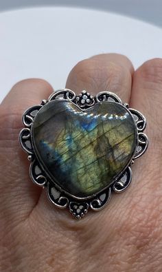 Huge heart carved blue green Labradorite rainbow moonstone Lovely vintage silver setting is low content silver Size 7 Can be re sized for you for $20 jeweler's fee About an inch long Ring is long covers from knuckle to knuckle. All rings are shipped in a nice gift box. Check out our over a THOUSAND great reviews Engraving is $4 per letter and is not always perfect depending on the piece. It can take a few days if the jeweler is busy. This is payable to Paypal Judithsltd@gmail.com Bohemian Heart-shaped Anniversary Rings, Collectible Heart-shaped Gemstone Jewelry, Vintage Labradorite Rings For Gift, Vintage Labradorite Gemstone Jewelry, Unique Handmade Heart Cut Jewelry, Bohemian Heart-shaped Rings For Gifts, Handmade Bohemian Heart Ring Gift, Handmade Bohemian Heart-shaped Rings, Bohemian Handmade Heart Ring Gift