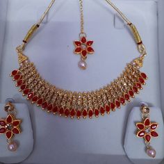 Step into the realm of timeless elegance with our Antique Gold Polki Choker, adorned with exquisite jhumkas and tikka, a stunning piece of Indian jewelry that exudes regal charm and sophistication. Crafted with meticulous attention to detail, this choker necklace features intricate antique gold polki work, reminiscent of traditional craftsmanship. The addition of jhumkas and tikka adds an extra layer of grace and beauty, making it a perfect choice for brides or anyone seeking to make a statement Red Kundan Tikka For Navratri, Red Stone Work Jewelry For Eid, Red Jewelry With Stone Work For Eid, Red Temple Jewelry For Eid, Red Jewelry For Eid Celebration, Eid Jewelry Sets With Latkans As A Gift, Red Jhumkas For Ceremonial Festivals, Eid Gift Jewelry Sets With Latkans, Red Ceremonial Jhumkas For Festivals