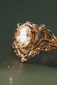 a gold ring with an oval diamond in the center