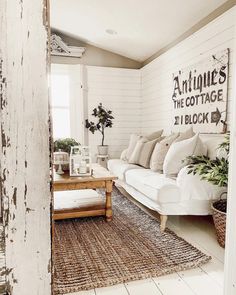 a living room filled with furniture and plants