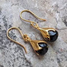 "TULY BLACK ONYX GOLD HOOK EARRINGS 18CT Gold Plated on Brass GEMSTONE BLACK ONYX Shiny Finished LooK. The Earrings are finished with an elegant shiny look. The stone on this earrings measures approximately 10mm x 10mm. The total length including hooks is 3.2cm. The gemstone \"BLACK ONYX\" enhances the strength of protective energies, self control, decision-making, intuition. It is a powerful stone as it absorbs negative energy of people to release mental stress and promote emotional well-being. Please note that the colour and translucency in gemstones differs from piece to piece due to natural variation." Black Stone Earrings Gold, Onyx Earrings Studs, Black And Gold Earrings, Black Stone Earrings, Black Onyx Jewelry, Black Onyx Earrings, Feather Bracelet, Dark Romantic, Jewellery Inspiration