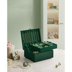 a green jewelry box sitting on top of a table