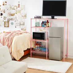 a bedroom with a bed, microwave and refrigerator in it next to a white rug