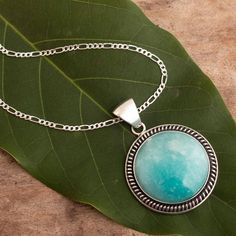 Glowing bright and mystical like the Andean moon, amazonite is said to bring luck in every hope and dream. Fabiana Quispe encases the natural gem in sterling silver featuring burnished accents in a design that is filled with enchanted minimalism. Round Amazonite Jewelry With Natural Stones, Amazonite Gemstone Pendant Jewelry, Silver Larimar Jewelry For Healing, Silver Amazonite Jewelry With Natural Stones, Bohemian Silver Amazonite Necklaces, Spiritual Round Larimar Jewelry, Silver Amazonite Gemstone Jewelry, Spiritual Silver Amazonite Necklaces, Untreated Jade Jewelry Gift