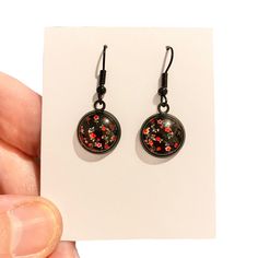 Adorable and cute are the best words to describe these 2cm little black earrings with handmade flower glass cabochons. Perfect little unique earrings for birthdays, or treats for yourself. Gorgeous little earrings that will get lots of attention and compliments. ❤️ SIZE : approximately 2cm drop. ❤️ MATERIALS: black settings, handmade black ear wires, glass cabochon, floral paper. ❤️ PROCESSING TIME : 1 business day. ❤️ You only pay postage on the 1st item,  everything else ships with it for FREE!  ❤️ PACKAGING  All orders come packaged in tissue paper with a pretty sticker. I do not use any plastic to wrap any products in order to protect our planet.  ❤️ CARING FOR YOUR JEWELLERY  To ensure the life of your jewellery: * please do not wear during bathing. * always put perfumes and lotions o Earrings Weird, Weird Earrings, Earrings Cool, Red Flower Earrings, Cool Earrings, Novelty Earrings, Goth Earrings, Gothic Earrings, Earrings Flower