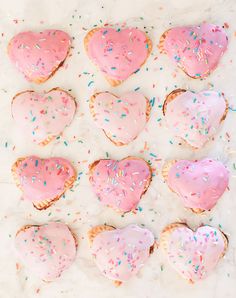 pink frosted heart shaped cookies with sprinkles