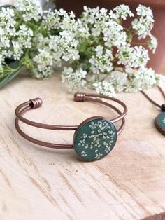 G R E E NA N D W H I T EThis stunning antique copper bangle contains a beautiful pressed real Queen Anne's Lace flower, set against a cool green resin background.It's part of a new range of jewellery,  all handmade in the UK.   These unique pieces make beautiful, unique gifts. Perfect for Mother's Day, Birthdays and Anniversaries, or just to treat yourself!  They would also make great bridesmaids gifts or be stunning as bridal jewellery.  Available in an on trend range of colours, they will comp Green Nickel-free Cuff Bracelet As Gift, Rose Gold Copper Bangle As Gift, Adjustable Nature-inspired Bangle As A Gift, Handmade Nature-inspired Bangle As Gift, Copper Bangle Gift, Green Cuff Bracelet Gift, Adjustable Copper Flower Jewelry, Flower Anniversary, Vintage Wedding Centerpieces